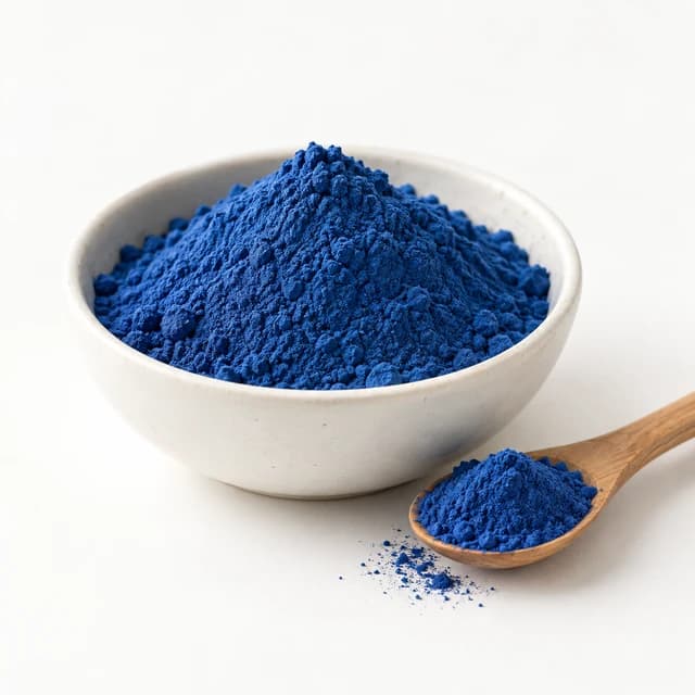 Blue spirulina powder in a white bowl